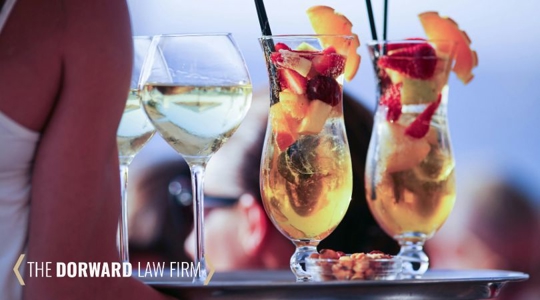 person with a tray of alcoholic drinks